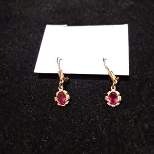 Gold earrings with a red stone